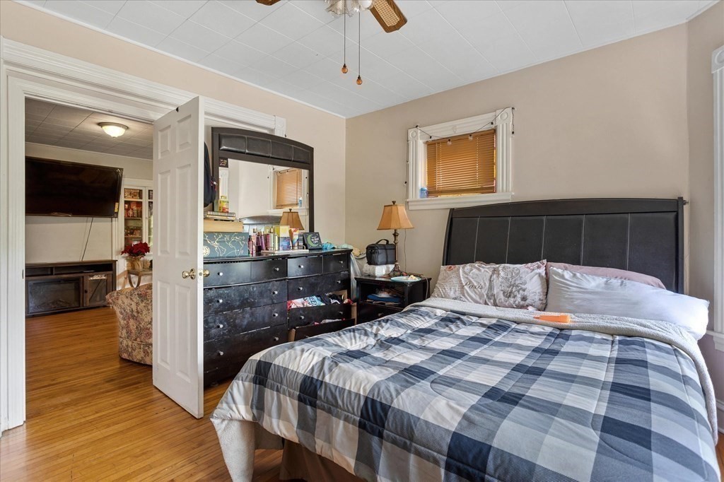 1550-1552 Main Street Worcester, MA 01603 - Photo 21 of 34 a bedroom with a bed and wooden floor