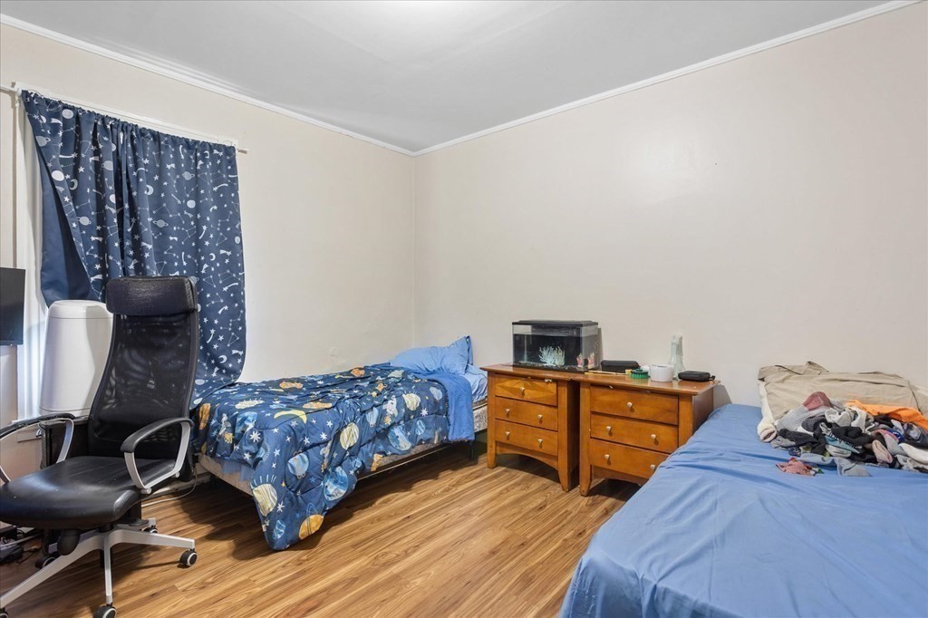 1550-1552 Main Street Worcester, MA 01603 - Photo 22 of 34 a bedroom with furniture and a wooden floor