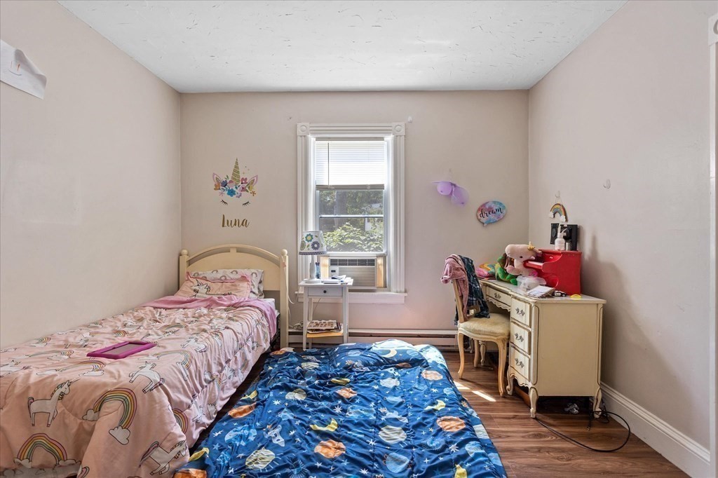 1550-1552 Main Street Worcester, MA 01603 - Photo 23 of 34 a bedroom with a bed and a window