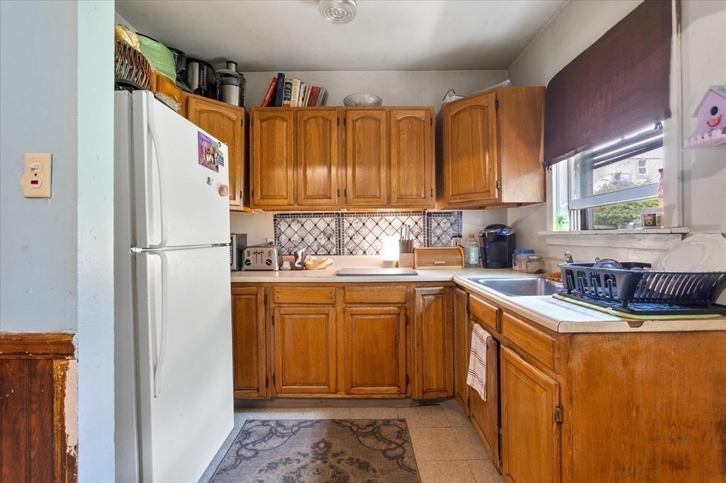 1550-1552 Main Street Worcester, MA 01603 - Photo 27 of 34 a kitchen with stainless steel appliances granite countertop a refrigerator sink and cabinets