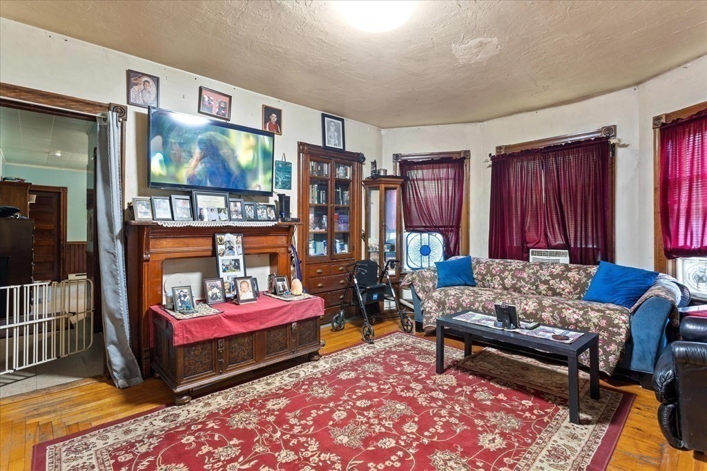 1550-1552 Main Street Worcester, MA 01603 - Photo 28 of 34 a living room with furniture and a rug