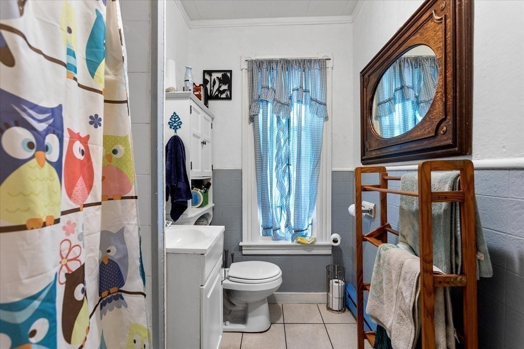 1550-1552 Main Street Worcester, MA 01603 - Photo 30 of 34 a bathroom with a toilet a sink and a mirror