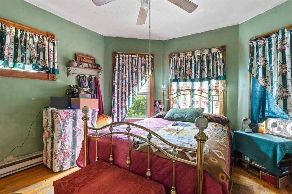 1550-1552 Main Street Worcester, MA 01603 - Photo 31 of 34 a bed sitting in a bedroom next to a window