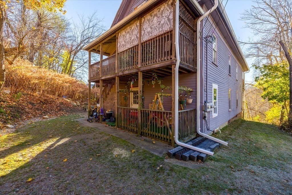 1550-1552 Main Street Worcester, MA 01603 - Photo 5 of 34 a view of a brick house with many windows next to a yard