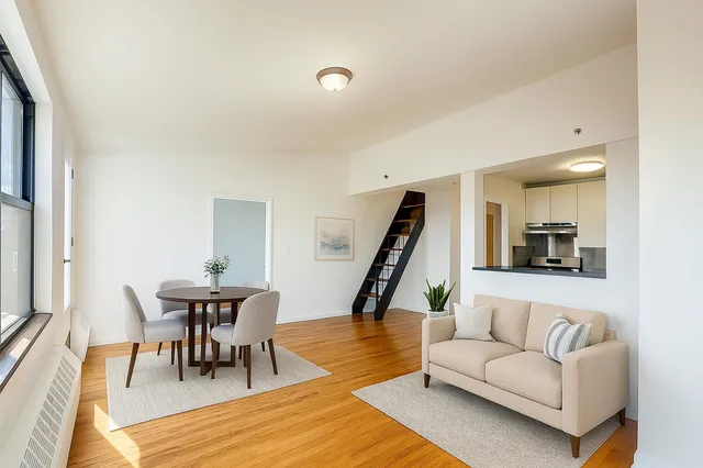 a living room with furniture and a wooden floor