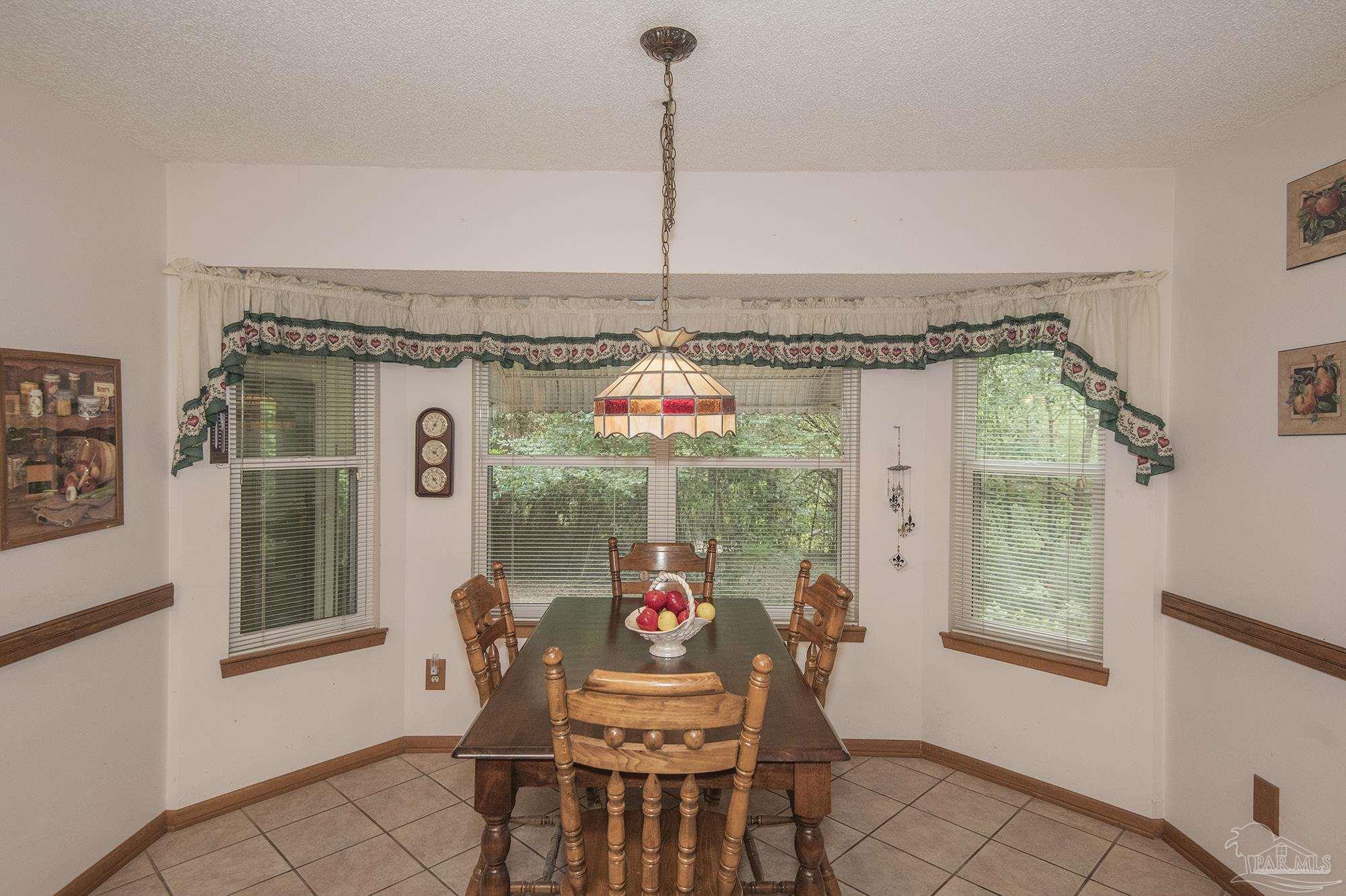 1210 Goldenrod Road Cantonment, FL 32533 - Photo 9 of 50 a dining room with furniture and window