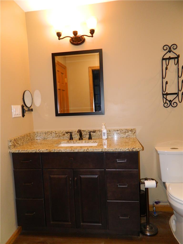 328 Pin Oak Road Stroudsburg, PA 18360 - Photo 29 of 42 A well-appointed bathroom features a dark wood vanity with granite counters and a clean white sink.