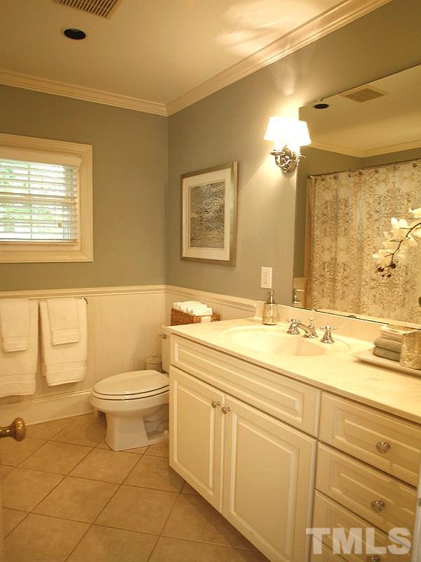 1307 Duplin Road Raleigh, NC 27607 - Photo 11 of 19 a bathroom with a granite countertop toilet sink and mirror