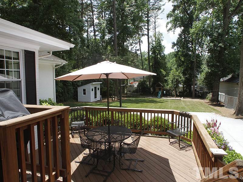 1307 Duplin Road Raleigh, NC 27607 - Photo 16 of 19 a view of a wooden deck with furniture and a table