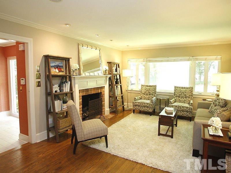 1307 Duplin Road Raleigh, NC 27607 - Photo 6 of 19 a living room with furniture and a fireplace