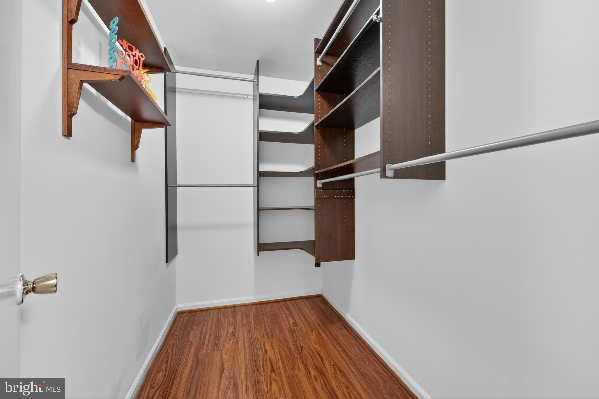 8139 Carrleigh Parkway Springfield, VA 22152 - Photo 21 of 27 a view of walk in closet with wooden floor