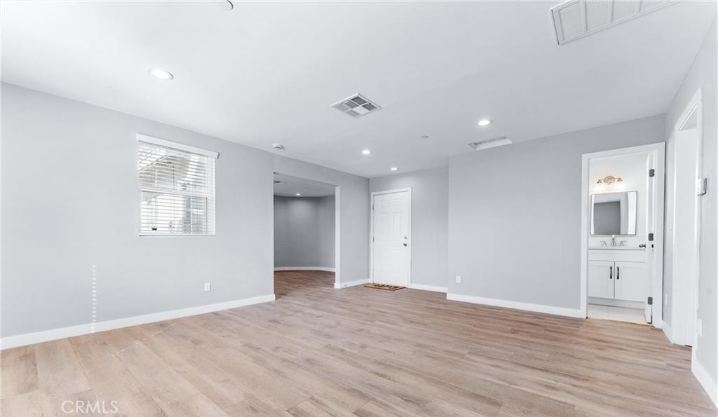 1531 West Orange Grove Avenue Pomona, CA 91768 - Photo 13 of 16 a view of an empty room with wooden floor and windows
