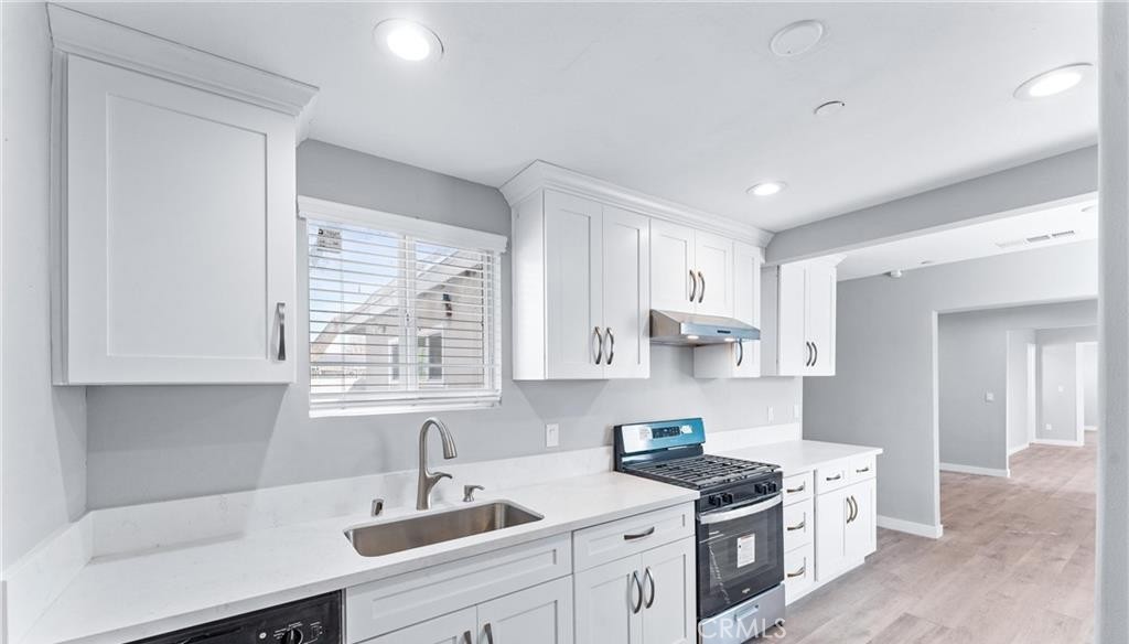 1531 West Orange Grove Avenue Pomona, CA 91768 - Photo 2 of 16 a kitchen with stainless steel appliances granite countertop a sink stove and cabinets