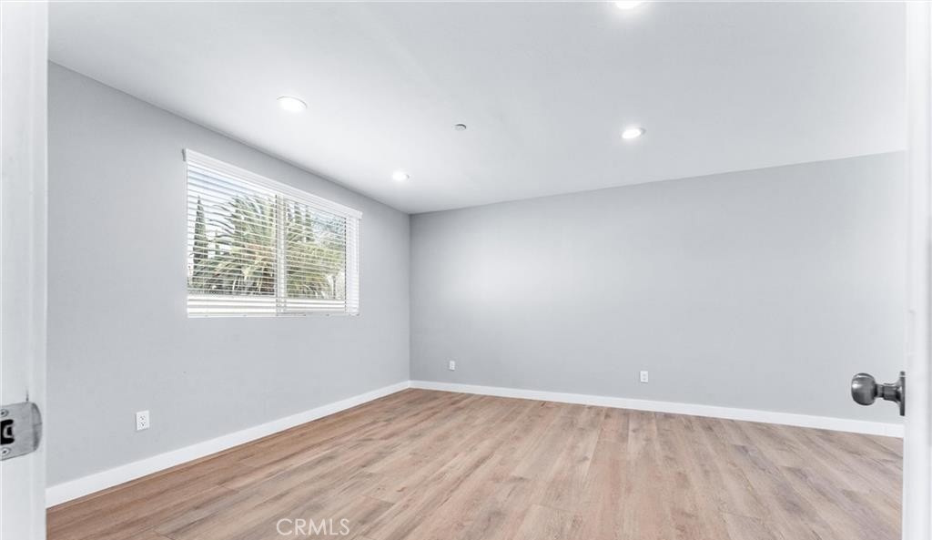 1531 West Orange Grove Avenue Pomona, CA 91768 - Photo 5 of 16 an empty room with wooden floor and windows
