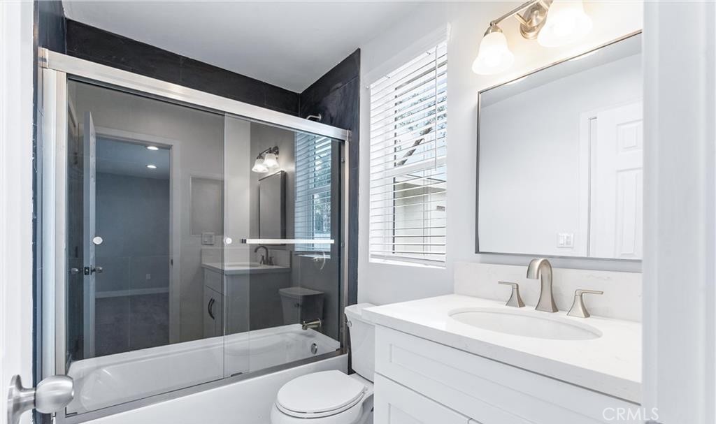 1531 West Orange Grove Avenue Pomona, CA 91768 - Photo 7 of 16 a bathroom with a sink a toilet and shower