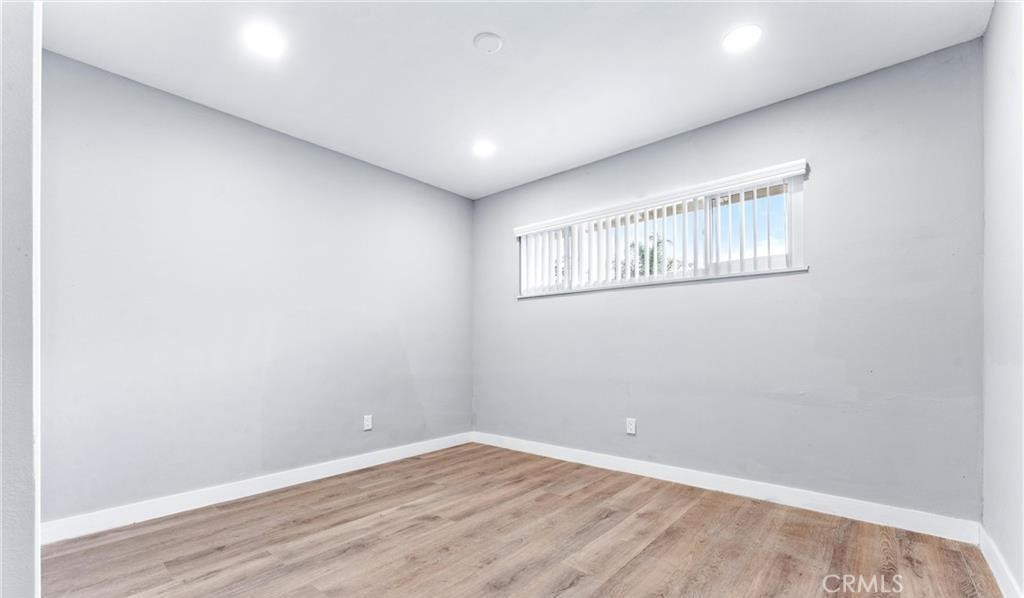 1531 West Orange Grove Avenue Pomona, CA 91768 - Photo 9 of 16 a view of an empty room with wooden floor and a window