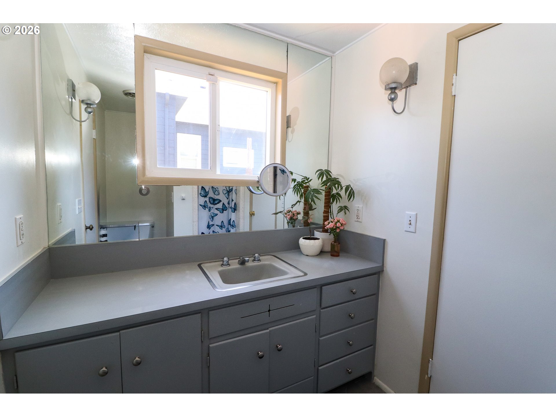7077 Main Street Springfield, OR 97478 - Photo 23 of 34 a bathroom with a sink a potted plant and a mirror