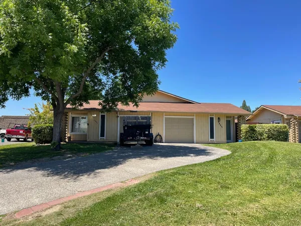 a view of a house with a yard and tree s