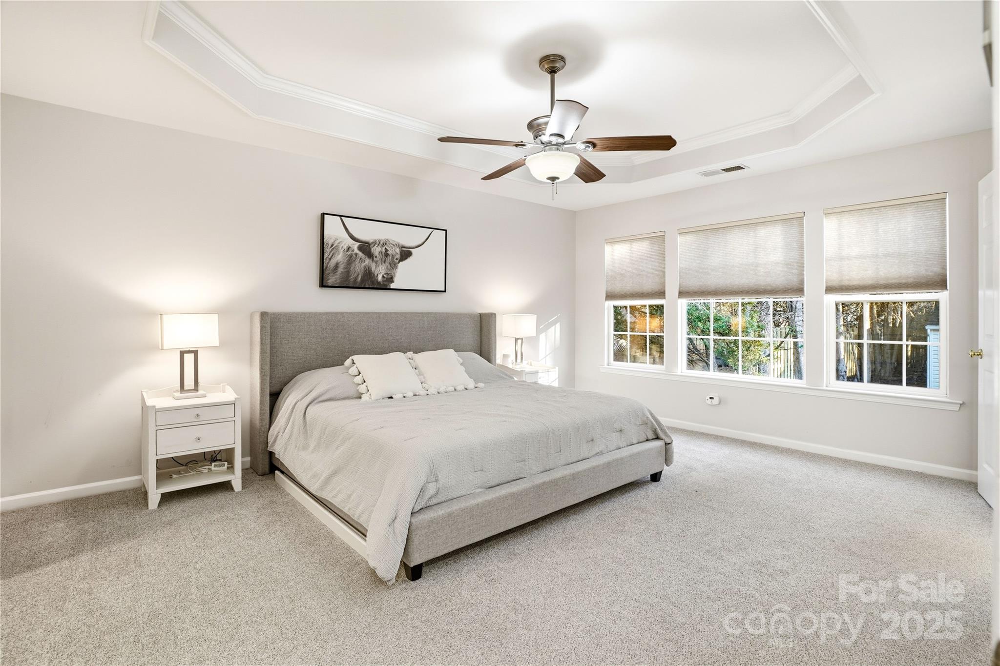 18015 Harbor Mist Road Cornelius, NC 28031 - Photo 17 of 37 a spacious bedroom with a large bed and a chandelier