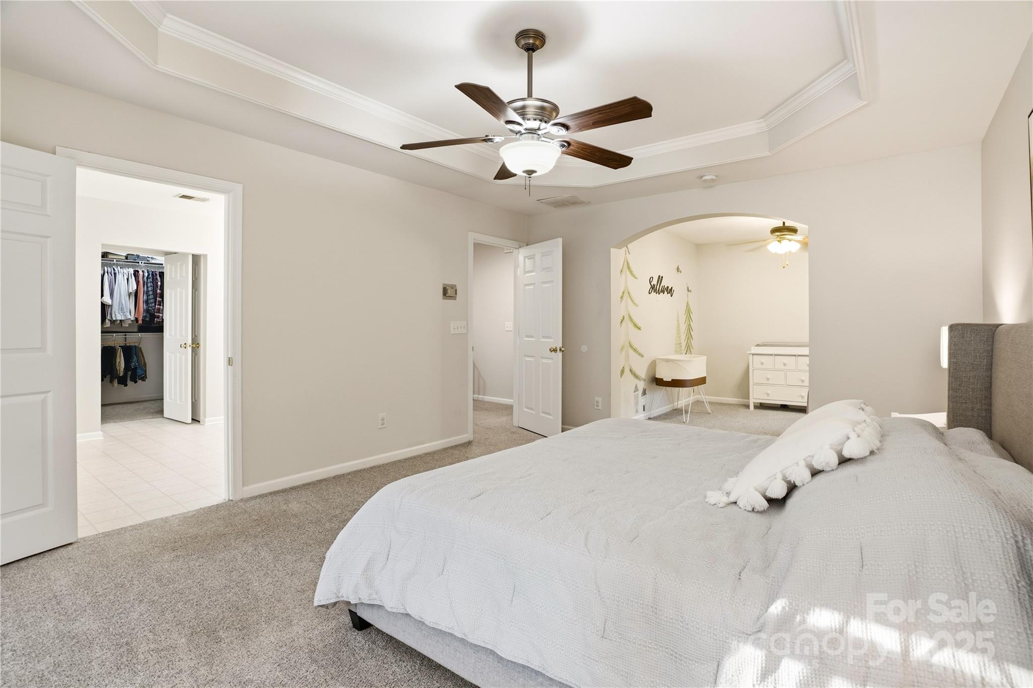 18015 Harbor Mist Road Cornelius, NC 28031 - Photo 18 of 37 a bedroom with a large bed and a chandelier