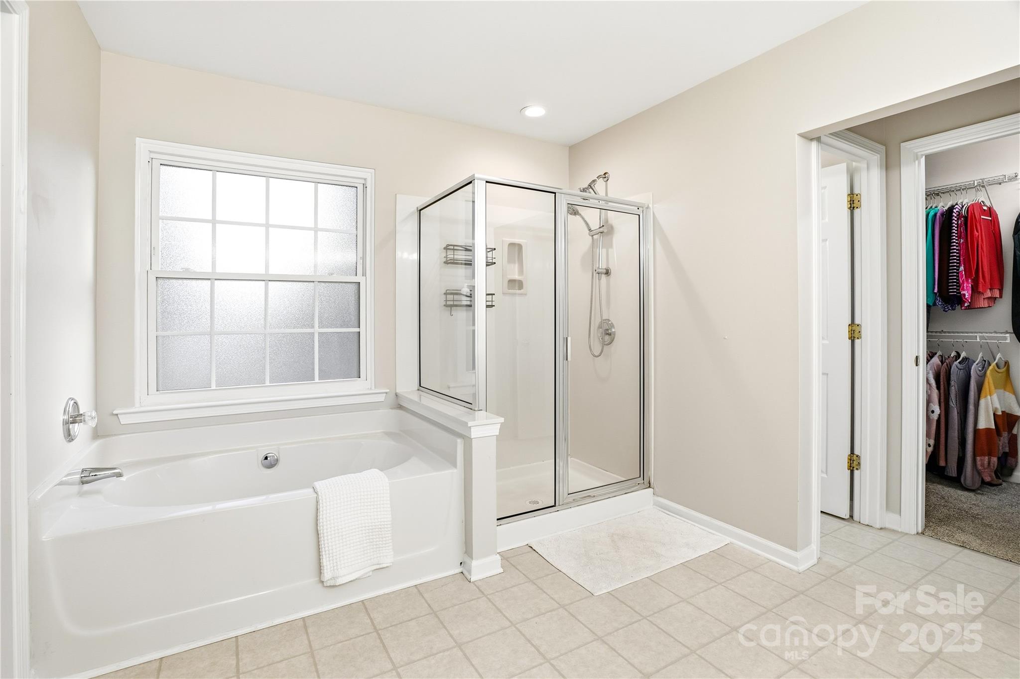 18015 Harbor Mist Road Cornelius, NC 28031 - Photo 21 of 37 a spacious bathroom with a tub shower and checkered floor