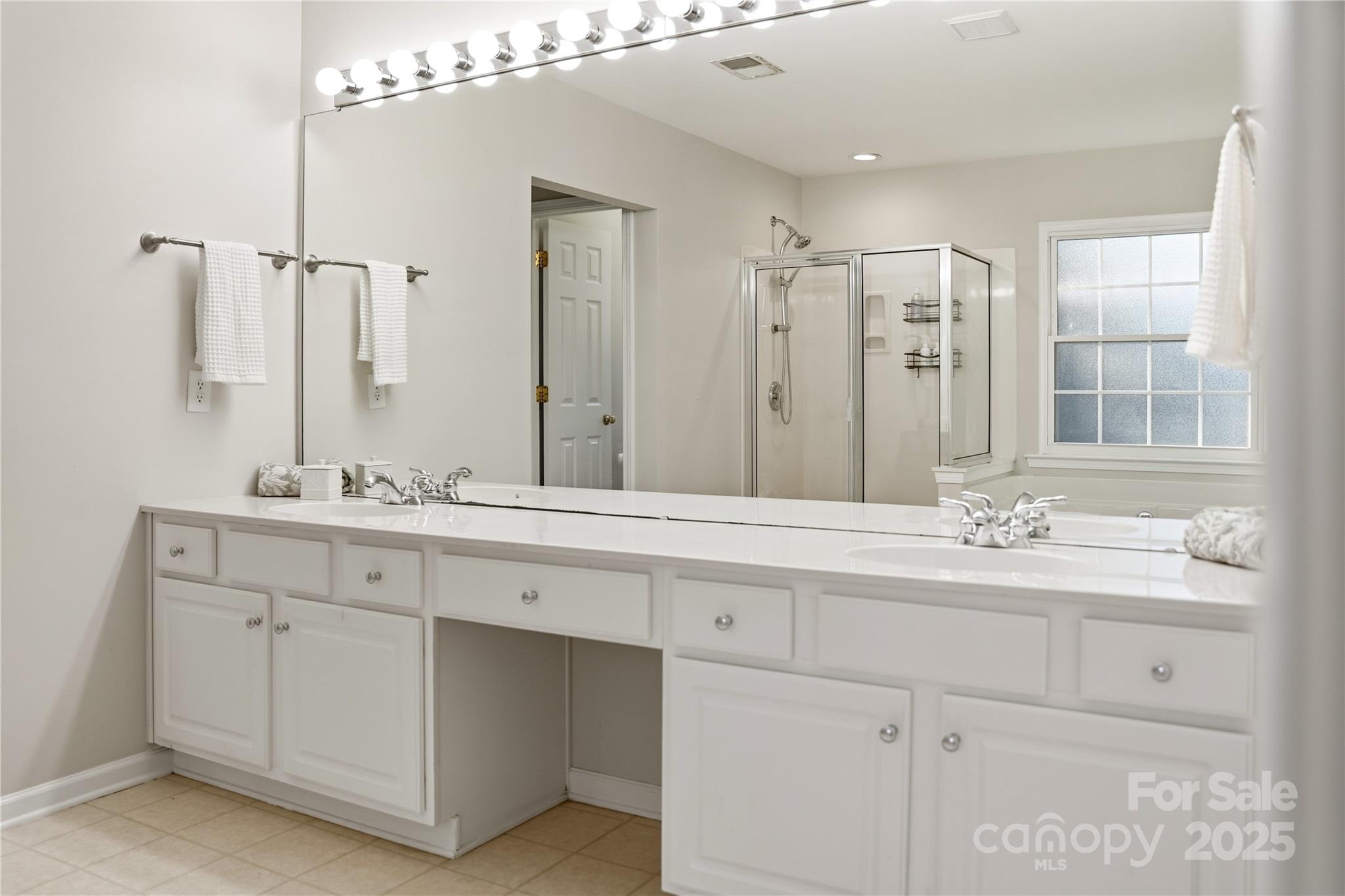 18015 Harbor Mist Road Cornelius, NC 28031 - Photo 22 of 37 a bathroom with double sink and a mirror
