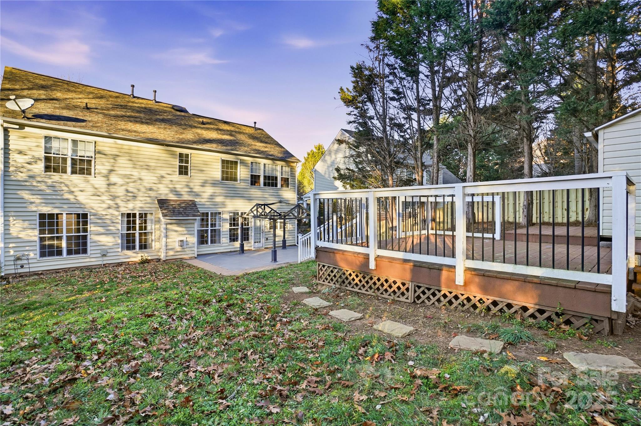 18015 Harbor Mist Road Cornelius, NC 28031 - Photo 33 of 37 a view of a house with a wooden deck and a big yard
