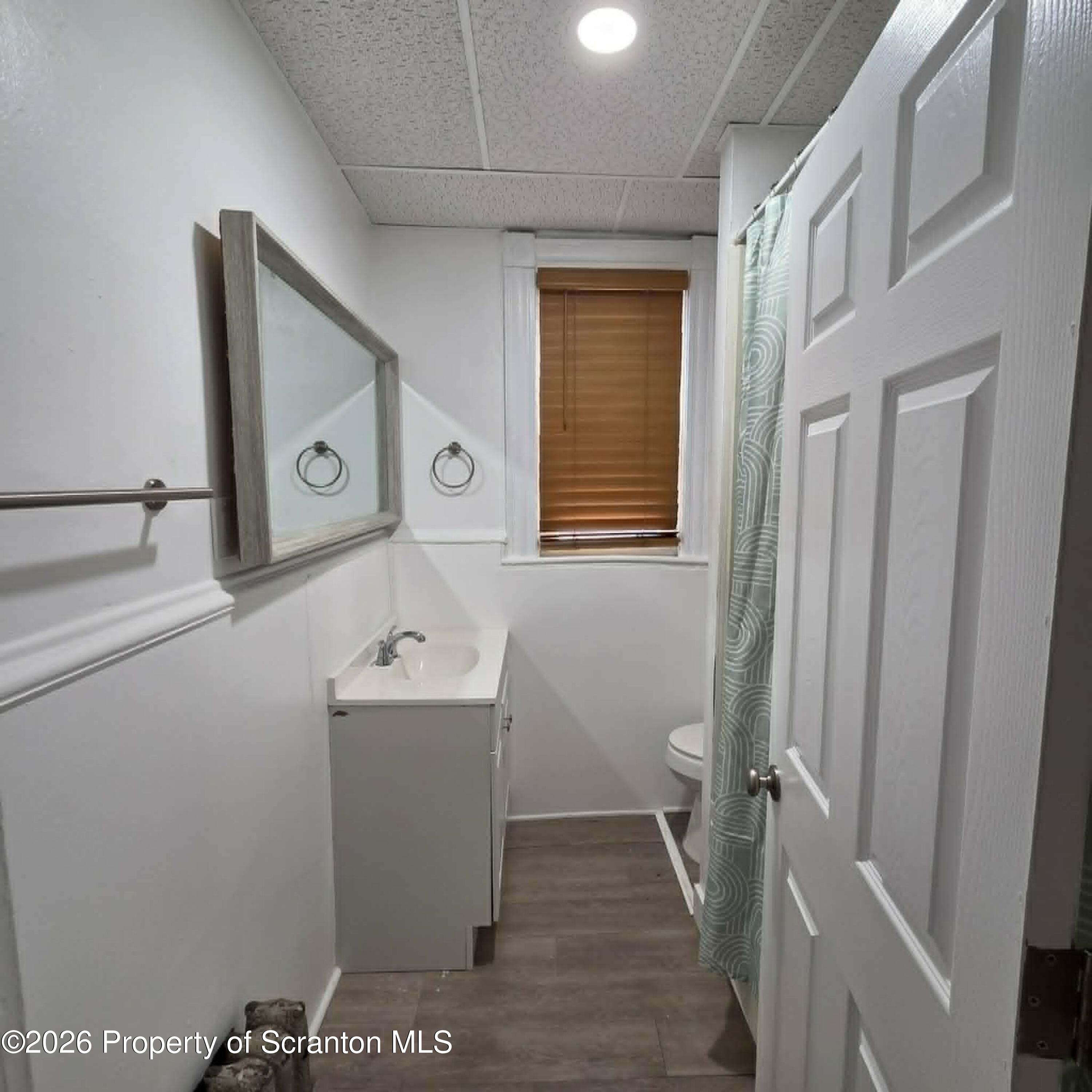 1606 Dickson Avenue, Unit 1 Scranton, PA 18509 - Photo 14 of 16 a bathroom with a sink and mirror with bathtub