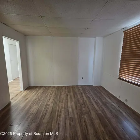 a view of an empty room and wooden floor