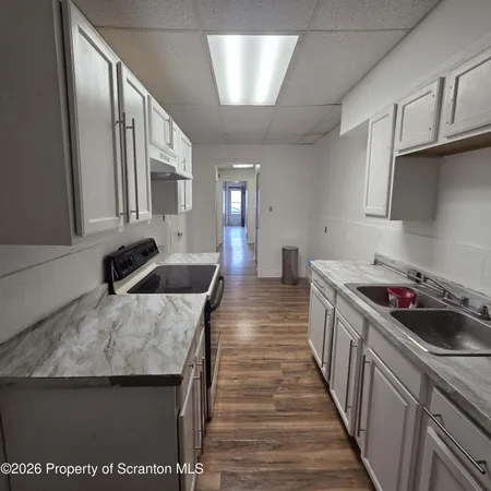 a kitchen with a sink stove and cabinets
