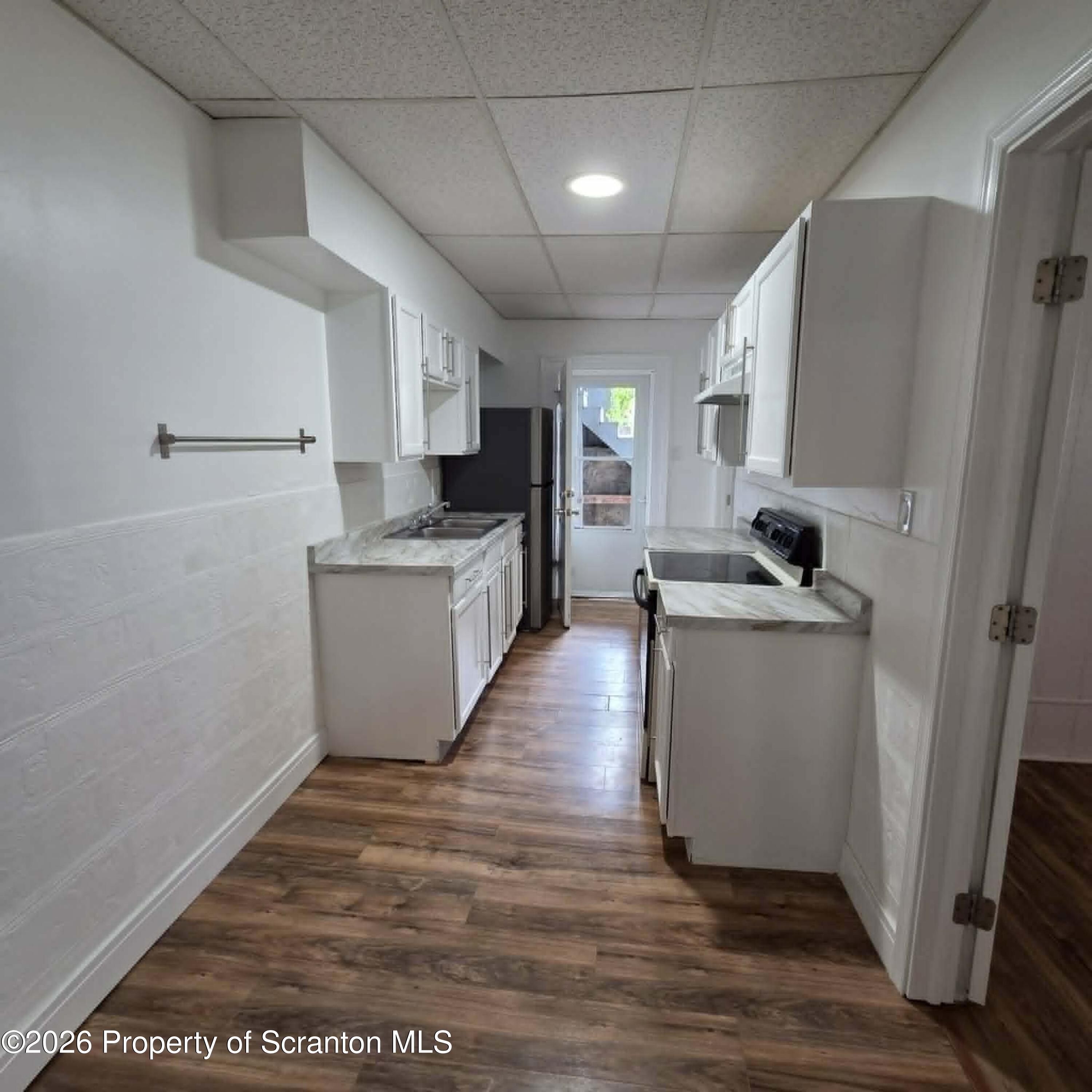 1606 Dickson Avenue, Unit 1 Scranton, PA 18509 - Photo 6 of 16 a kitchen with sink a microwave and refrigerator