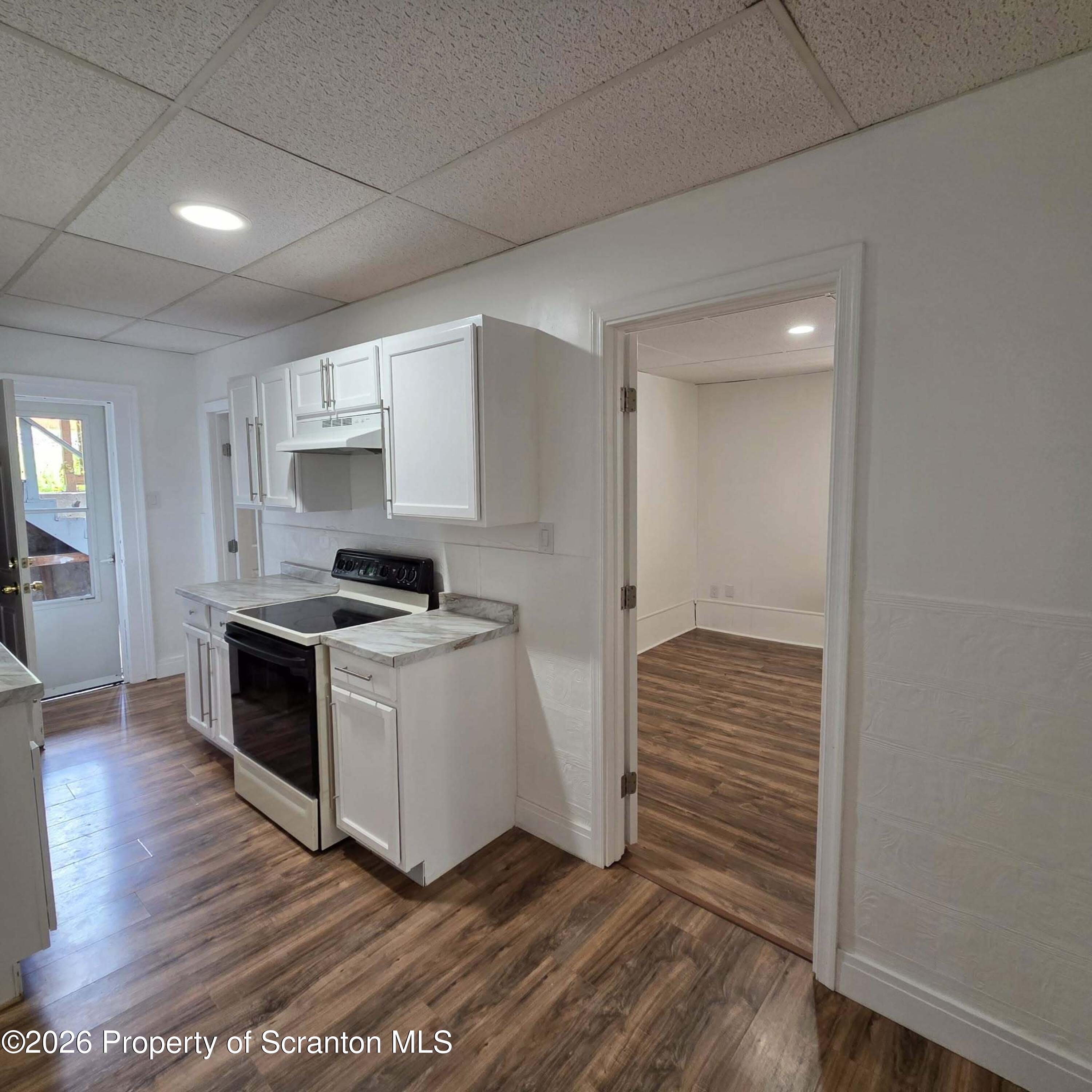 1606 Dickson Avenue, Unit 1 Scranton, PA 18509 - Photo 9 of 16 a kitchen with wooden floors and white appliances