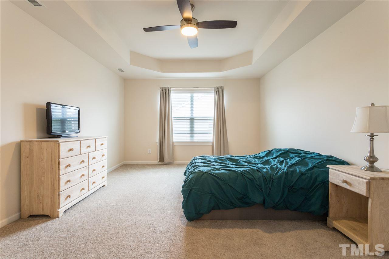 333 Hope Valley Road Knightdale, NC 27545 - Photo 11 of 22 a bedroom with a bed and a flat screen tv