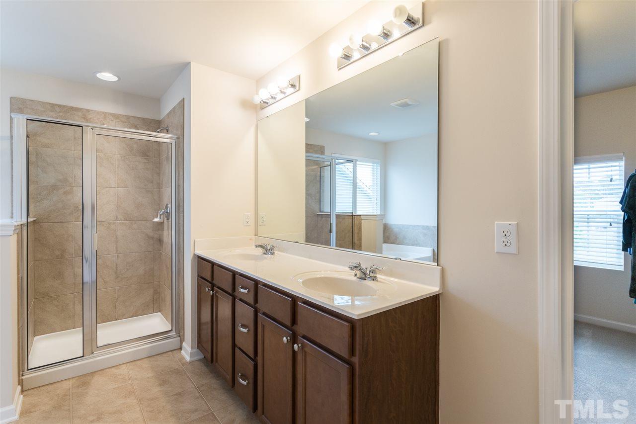 333 Hope Valley Road Knightdale, NC 27545 - Photo 13 of 22 a bathroom with a sink mirror and shower