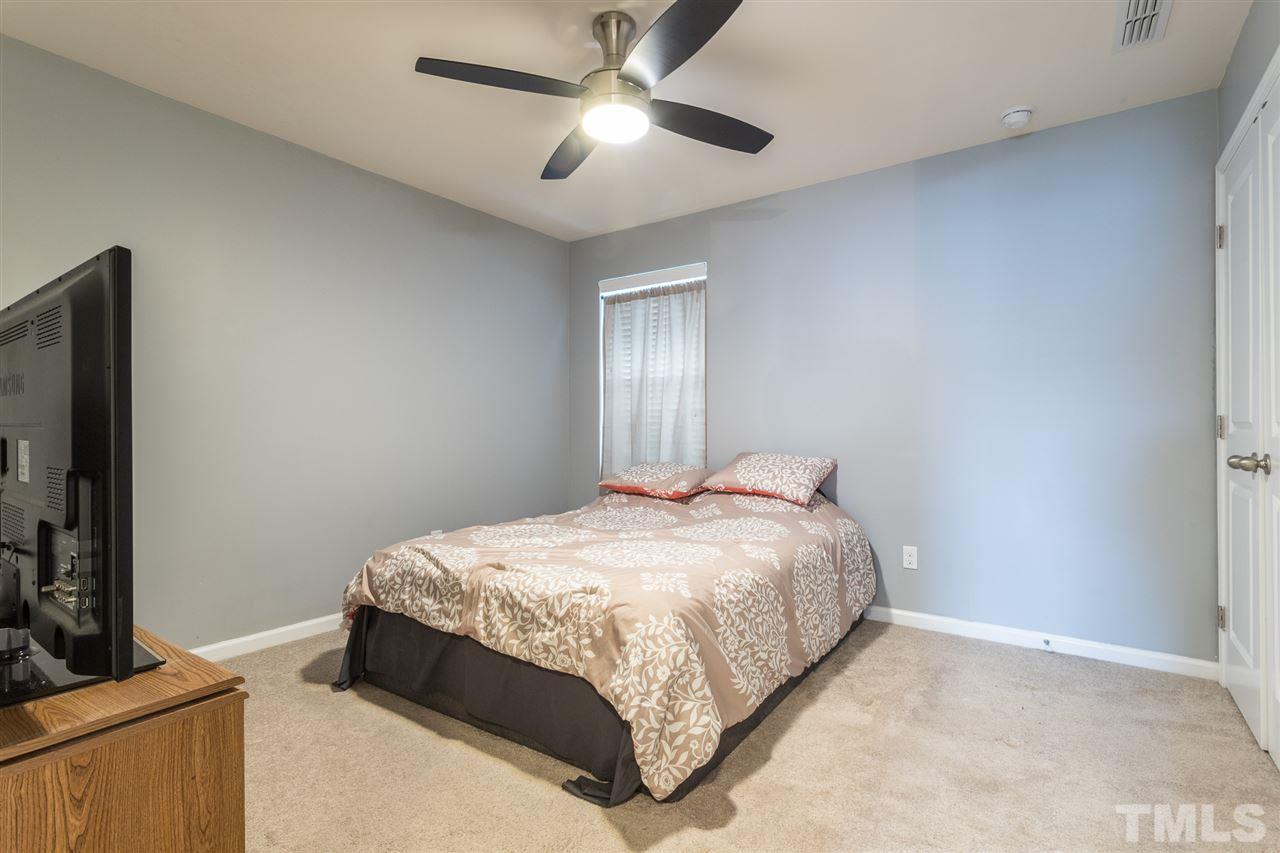 333 Hope Valley Road Knightdale, NC 27545 - Photo 17 of 22 a bedroom with a bed and a flat screen tv