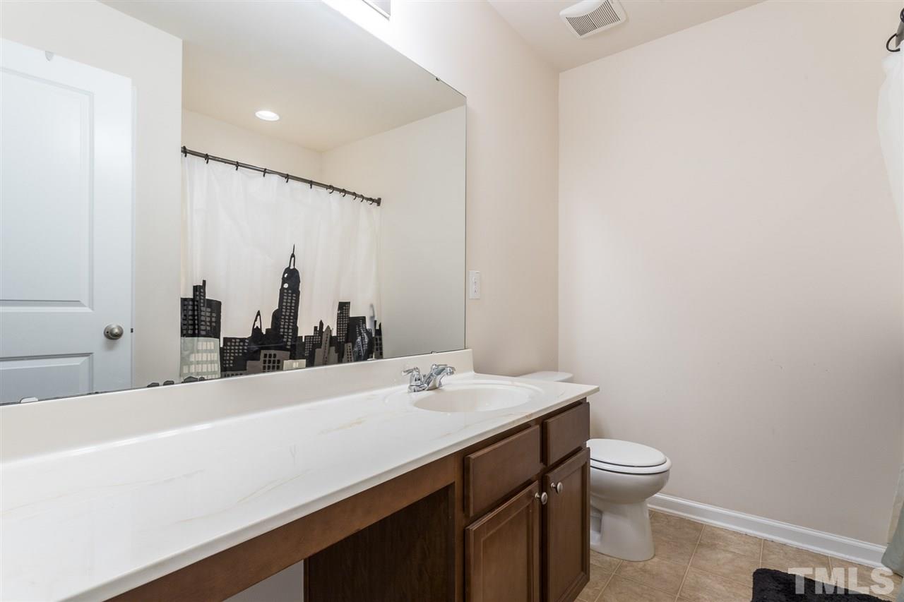 333 Hope Valley Road Knightdale, NC 27545 - Photo 18 of 22 a bathroom with a sink a toilet and mirror