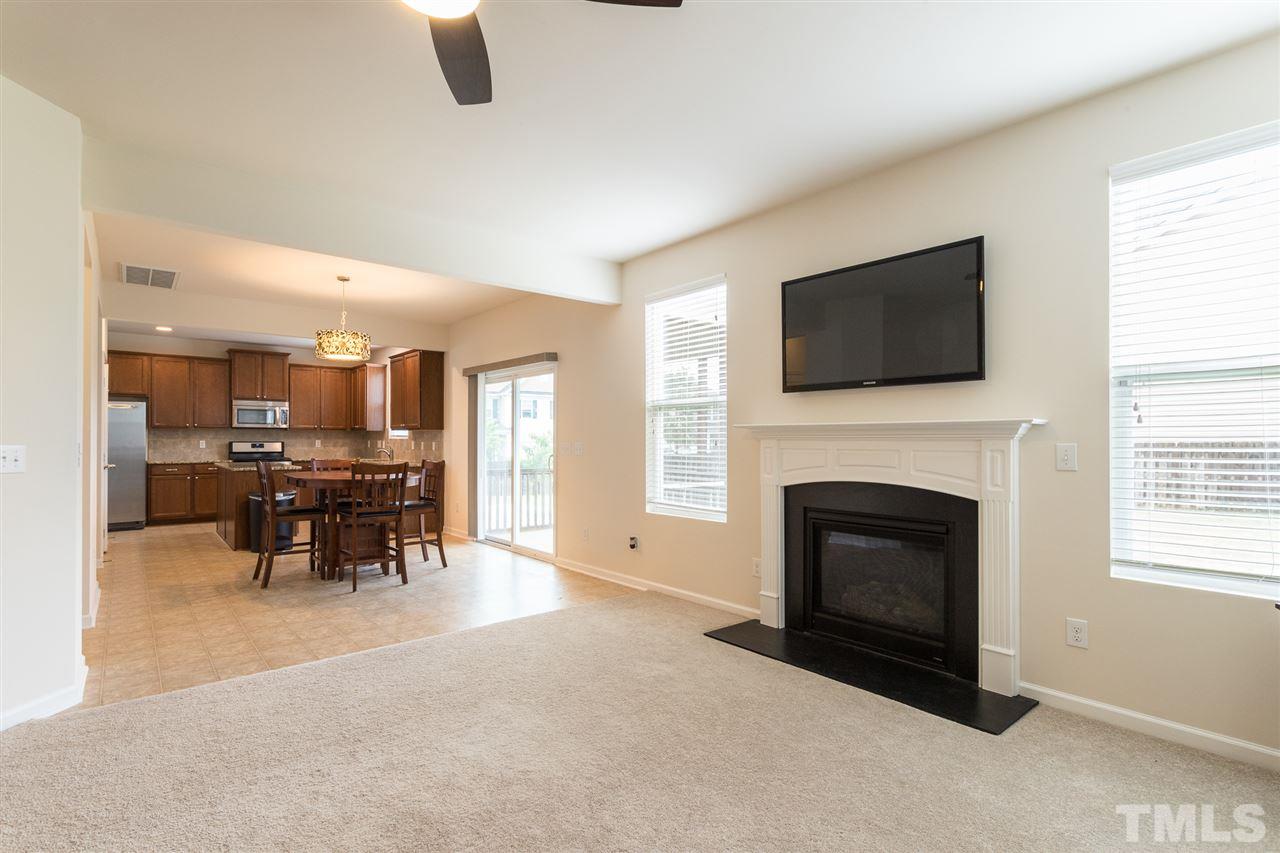 333 Hope Valley Road Knightdale, NC 27545 - Photo 5 of 22 a living room with furniture a fireplace and a flat screen tv