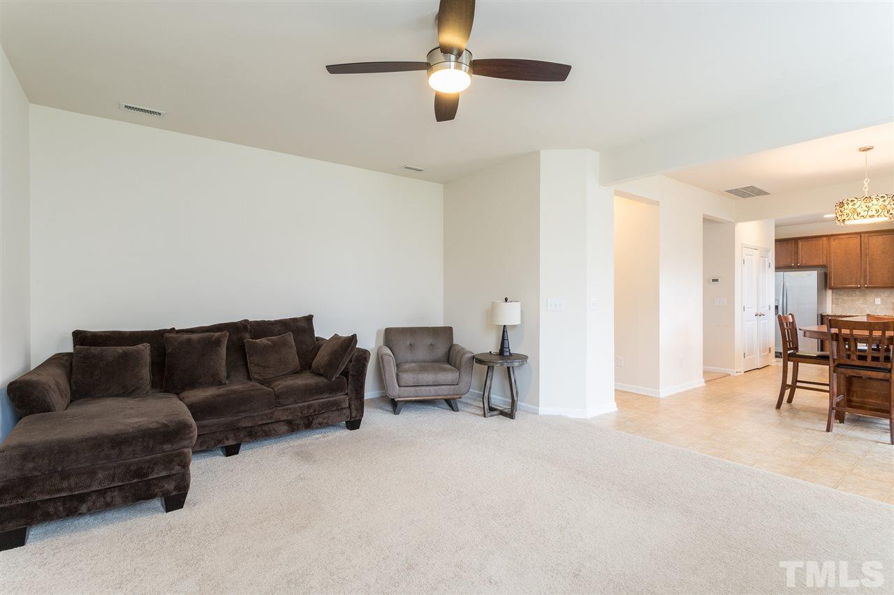 333 Hope Valley Road Knightdale, NC 27545 - Photo 6 of 22 a living room with furniture and a dining table with projector