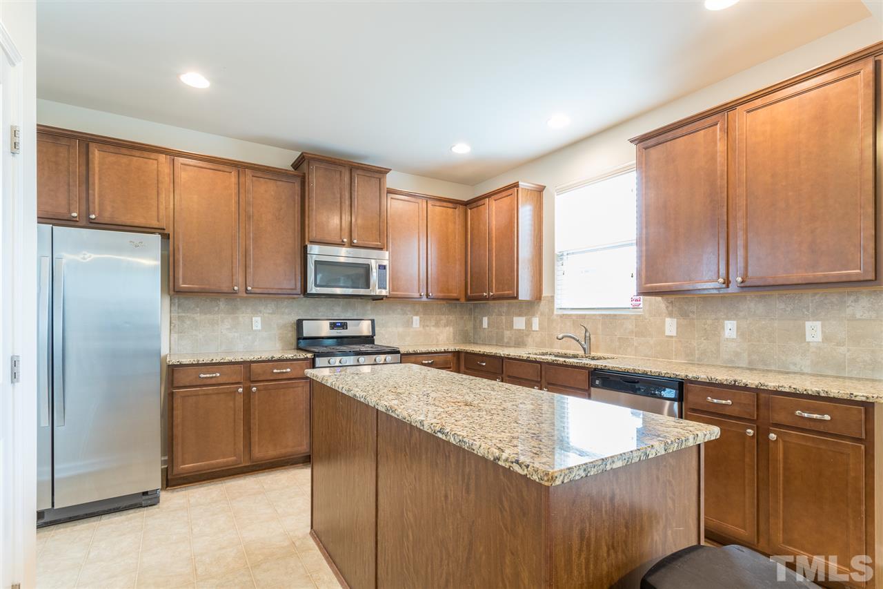333 Hope Valley Road Knightdale, NC 27545 - Photo 9 of 22 a kitchen with stainless steel appliances granite countertop a refrigerator sink and cabinets