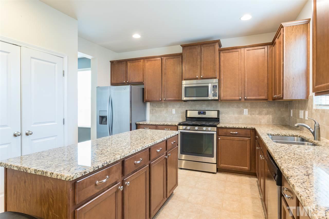 333 Hope Valley Road Knightdale, NC 27545 - Photo 10 of 22 a kitchen with granite countertop a sink stove and refrigerator