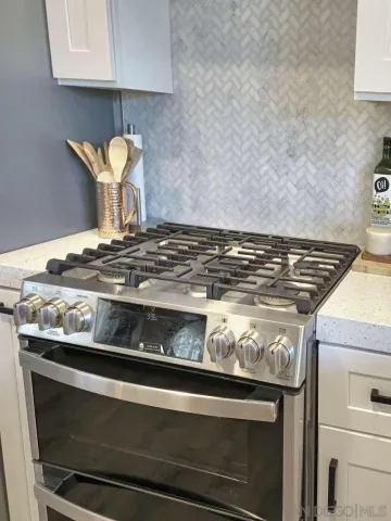 a stove top oven sitting inside of a kitchen