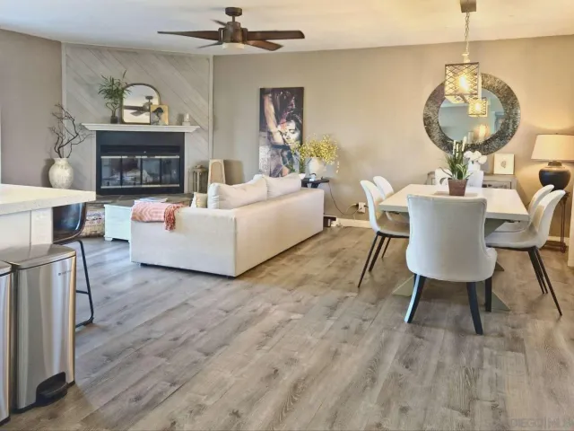 a living room with furniture fireplace and a large window