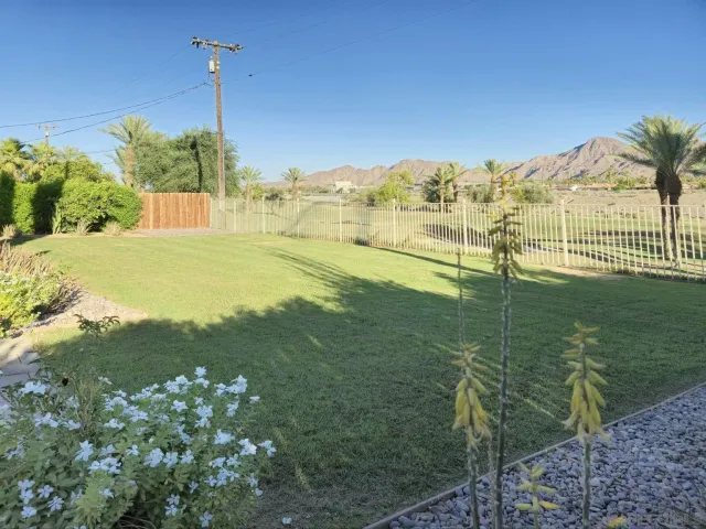 a view of a house with a yard patio and fire pit