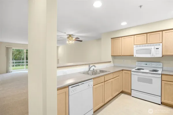 a kitchen with a sink stove and cabinets