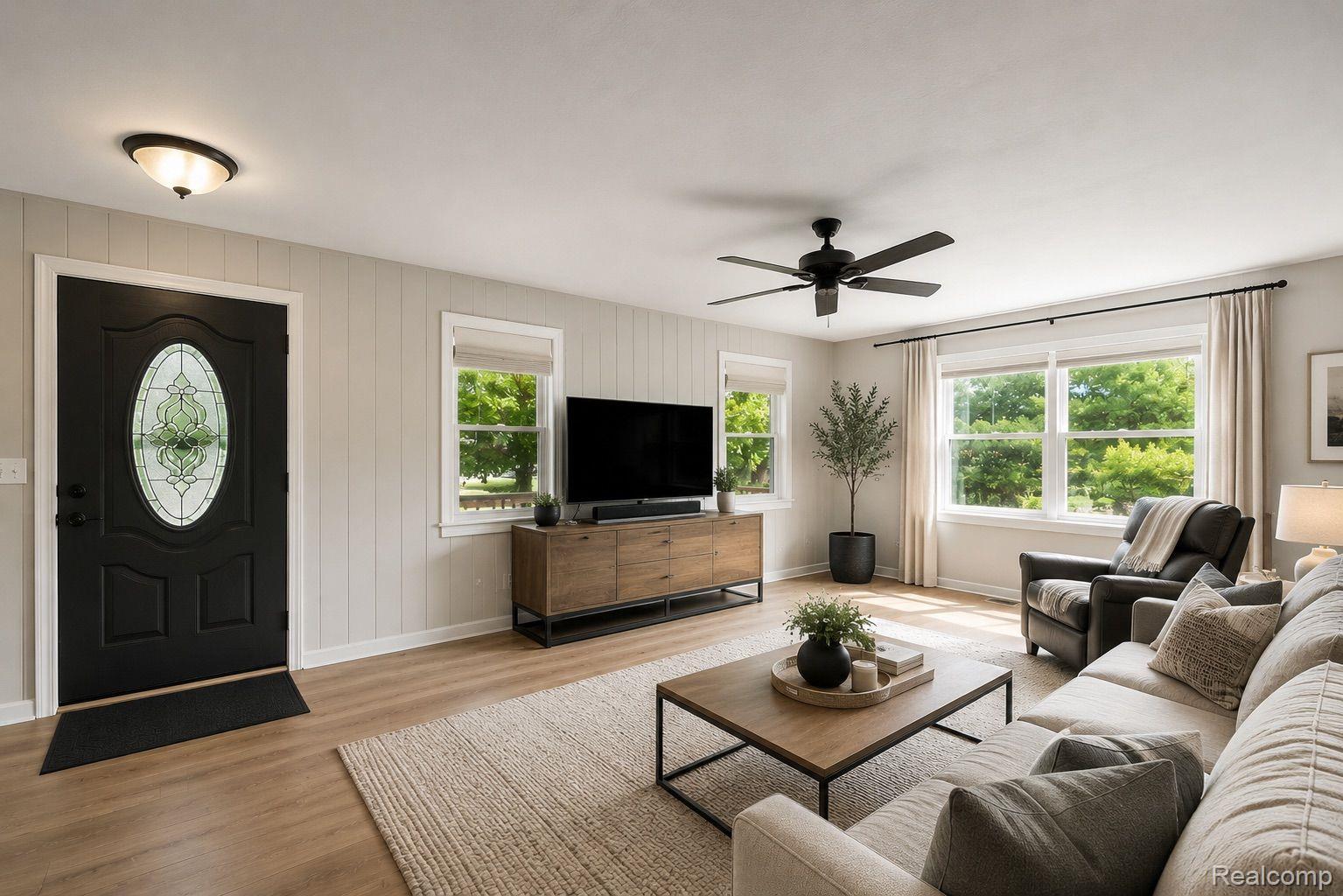 76565 McFadden Road Armada, MI 48005 - Photo 11 of 95 Wood-finish flooring, white paneled wall accents, and multiple windows