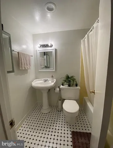 a bathroom with a sink toilet and a mirror