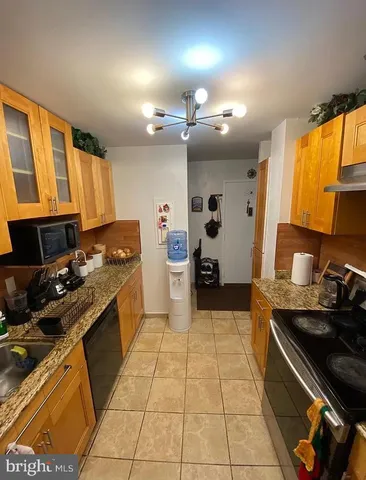 a kitchen with a sink appliances and cabinets
