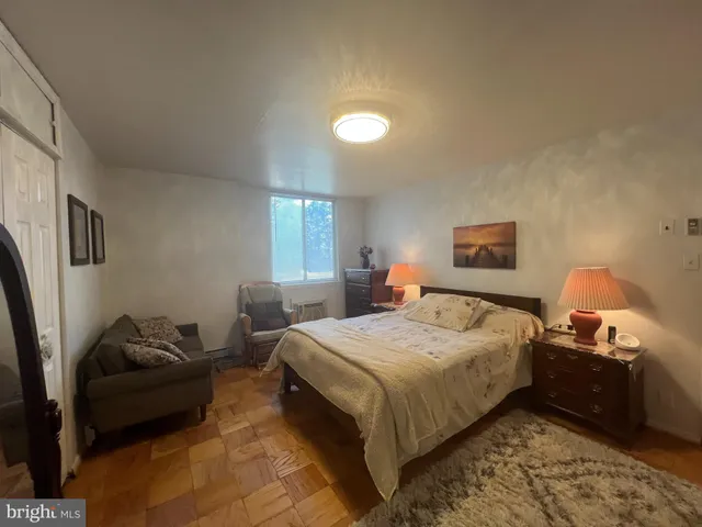 a bedroom with a bed and a couch