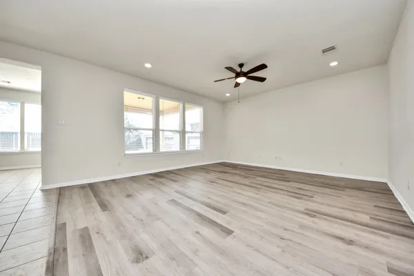 an empty room with windows and closet