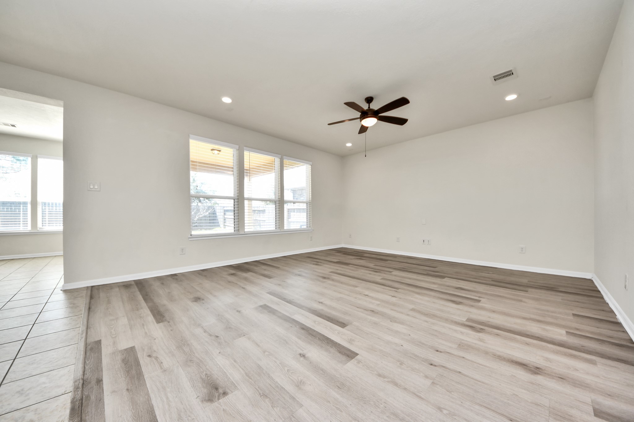 24123 Adobe Ridge Lane Katy, TX 77493 - Photo 11 of 45 wooden floor in an empty room with a window